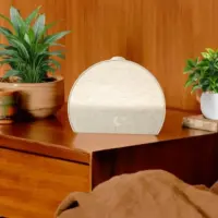 Hatch Restore 3 smart sleep device on a bedside table with soft ambient lighting