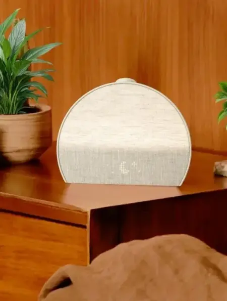 Hatch Restore 3 smart sleep device on a bedside table with soft ambient lighting