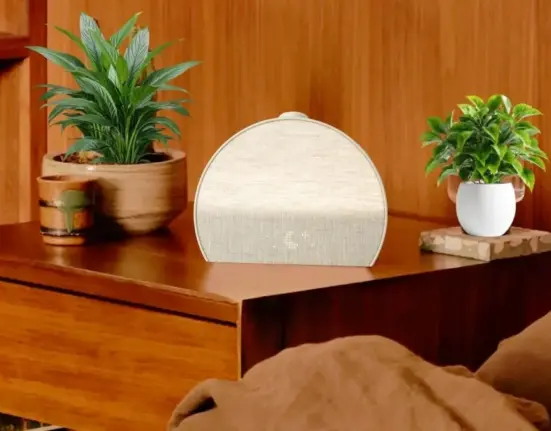 Hatch Restore 3 smart sleep device on a bedside table with soft ambient lighting