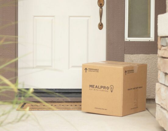 Cardboard parcel delivered beside a door for a cross-border clothing order