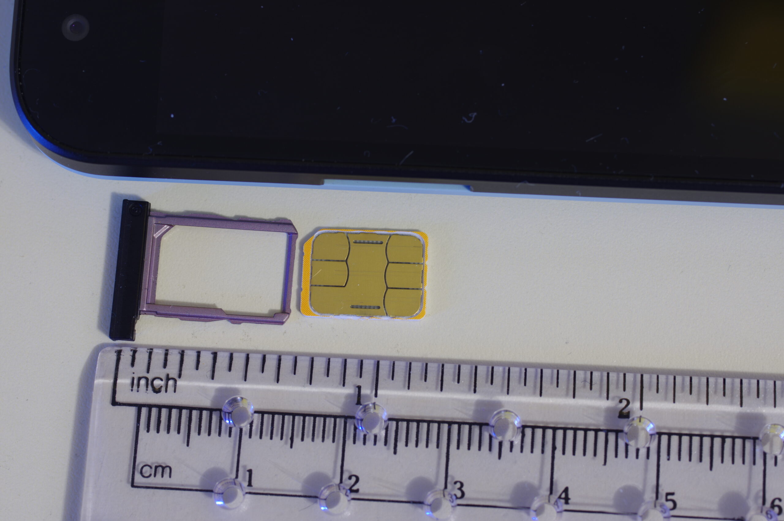 Nano SIM card next to its plastic tray, representing the switch from physical SIM to digital eSIM travel plans