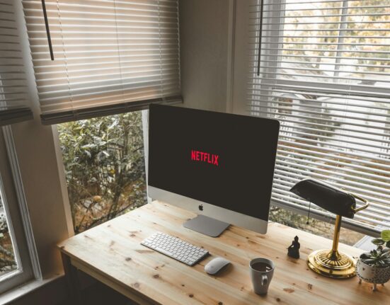 Wireless keyboard and mouse on a bright office desk