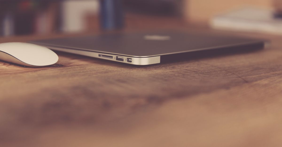 Laptop and wireless mouse on a modern office desk workspace