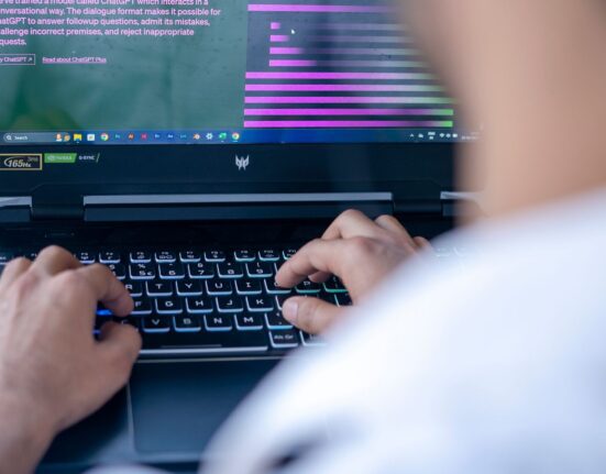Professional using an AI chatbot on a laptop for research, illustrating AI research agents vs manual chatbot research