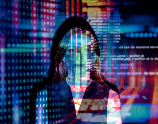 Digital code projected over a person representing how to compare antivirus plans for multiple devices in the UK