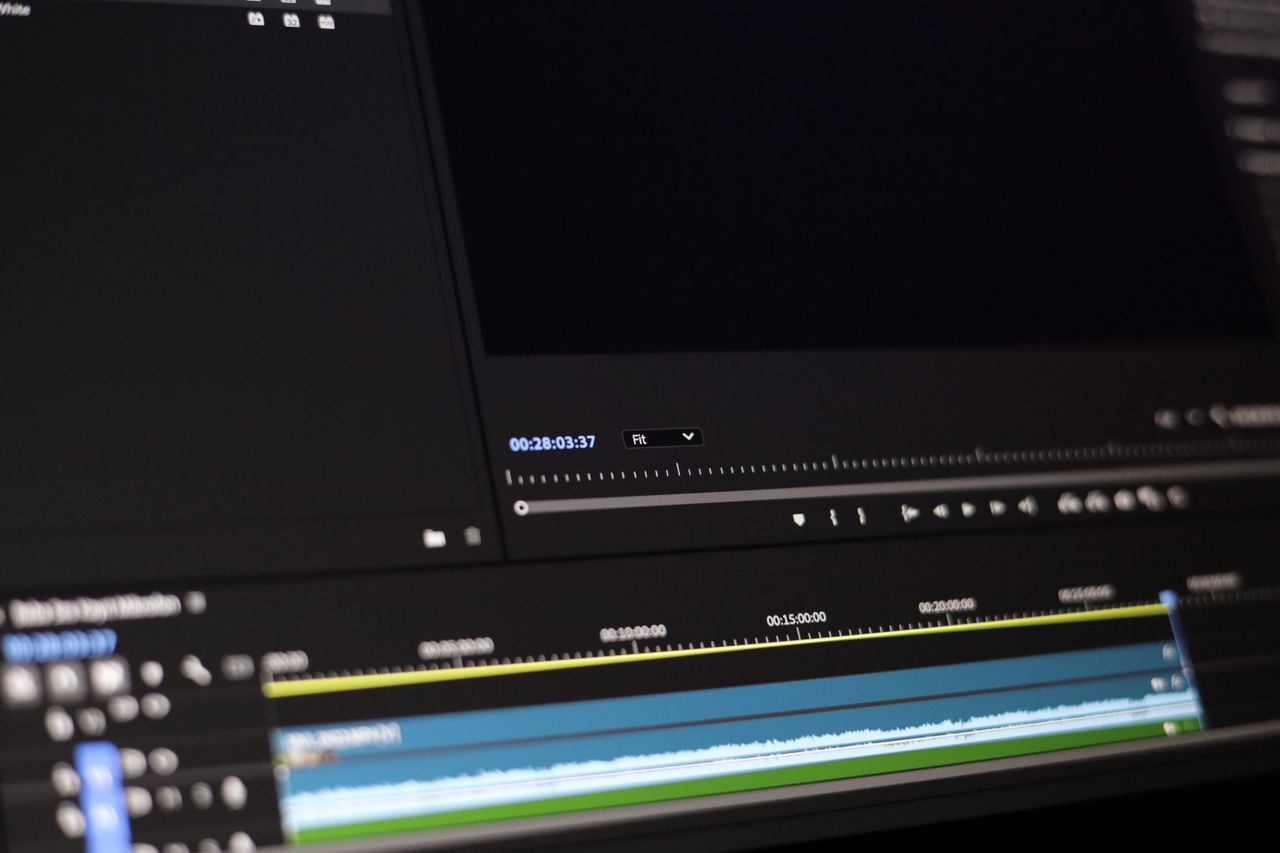 Video editing software timeline and controls shown on a monitor