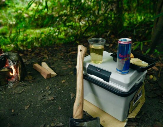 Camping site with cooler and gear, representing the best hard cooler for camping in Canada