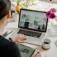Person designing a website on a laptop while choosing a WordPress theme for an online store