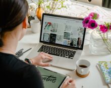 Person designing a website on a laptop while choosing a WordPress theme for an online store