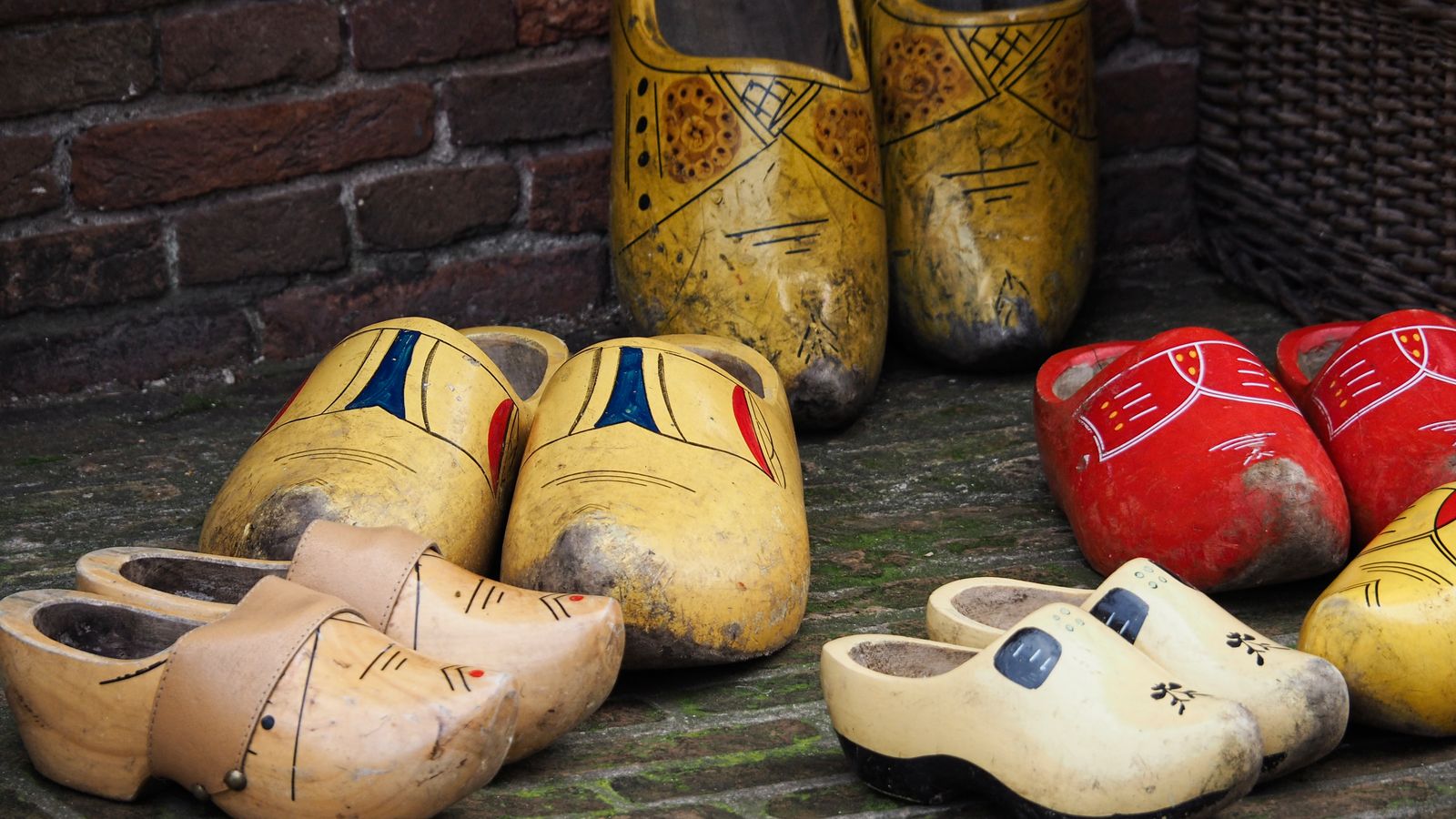 Traditional clogs lined up for a footwear comparison of clogs and open-toe sandals