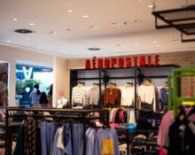 Clothing store with garments hanging on racks, how to compare off price clothing finds