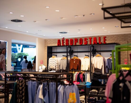 Clothing store with garments hanging on racks, how to compare off price clothing finds