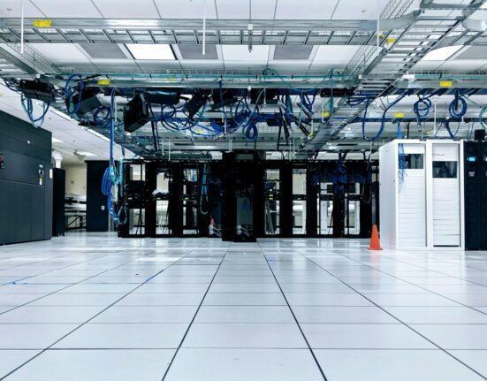 Server room with rows of cabinets illustrating dedicated server vs VPS hosting for business applications