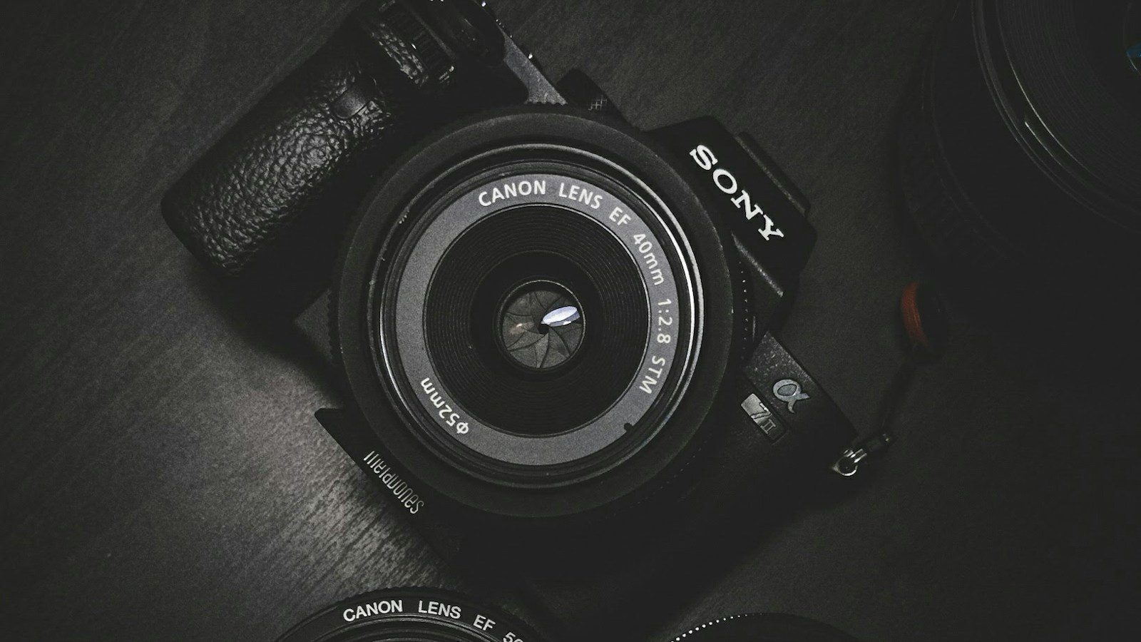 Camera on a dark surface representing an ecommerce promo video workflow