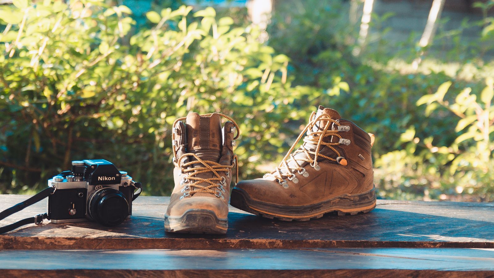 Pair of hiking boots resting beside gear before a hike