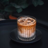 Glass of iced coffee with ice cubes for coffee concentrate vs cold brew
