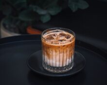 Glass of iced coffee with ice cubes for coffee concentrate vs cold brew