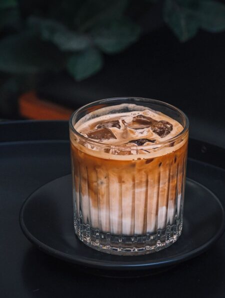 Glass of iced coffee with ice cubes for coffee concentrate vs cold brew