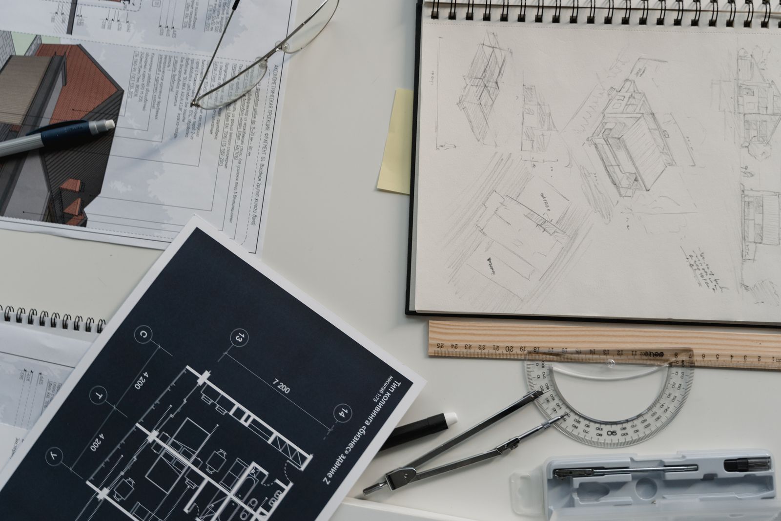 Design sketches and plans on a desk representing a logo design project brief