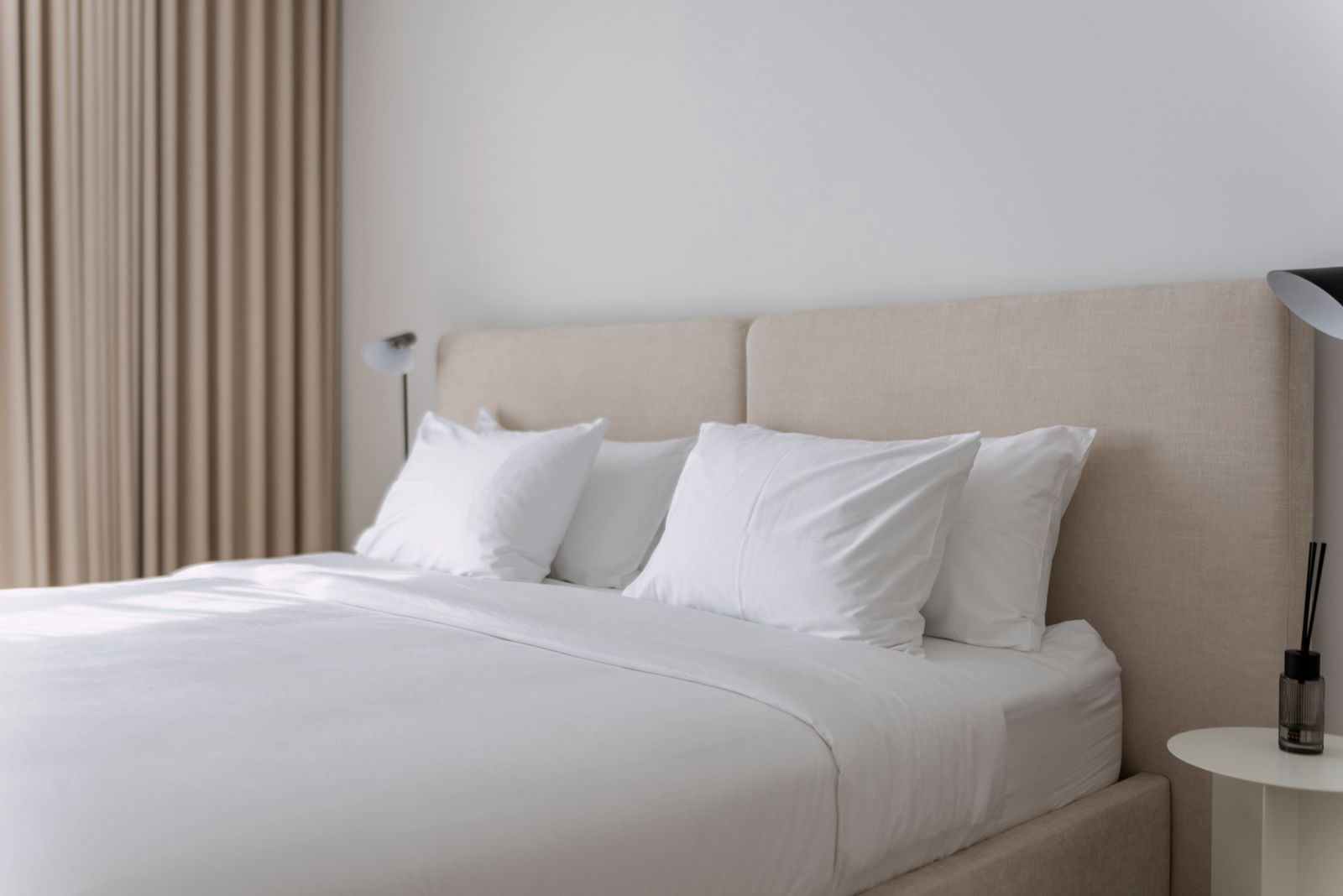 Calm neutral bedroom with natural fibre bedding and cotton or linen sheets