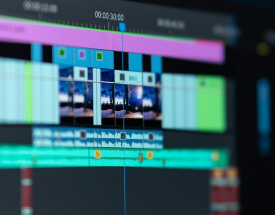 Monitor showing video editing software while planning prompts for AI explainer videos