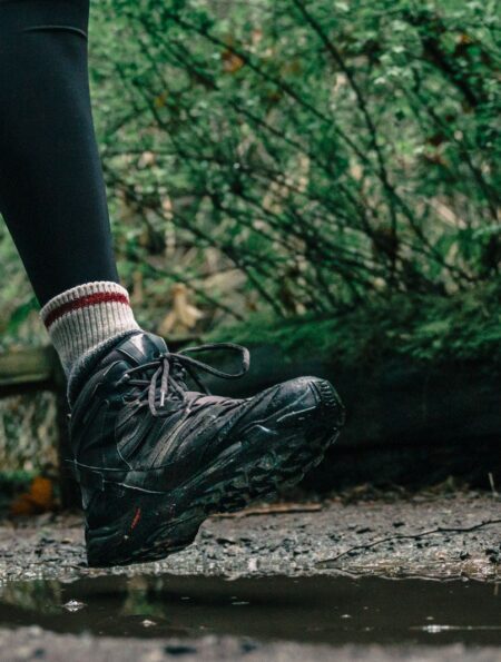 Hiker wearing waterproof hiking boots on a rocky trail