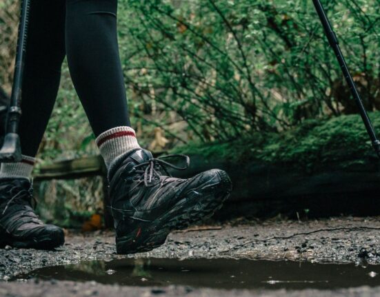 Hiker wearing waterproof hiking boots on a rocky trail