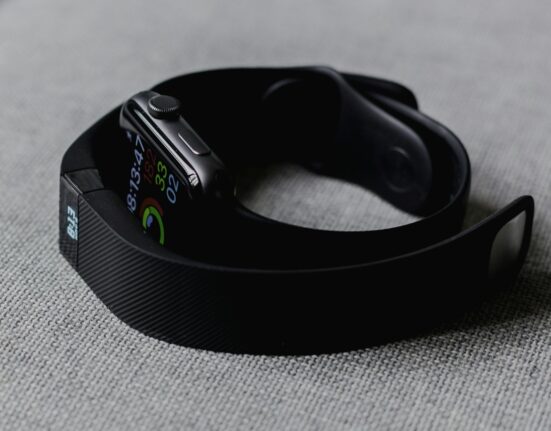Black fitness tracker band on a grey surface for choosing a wearable metabolic health tracker