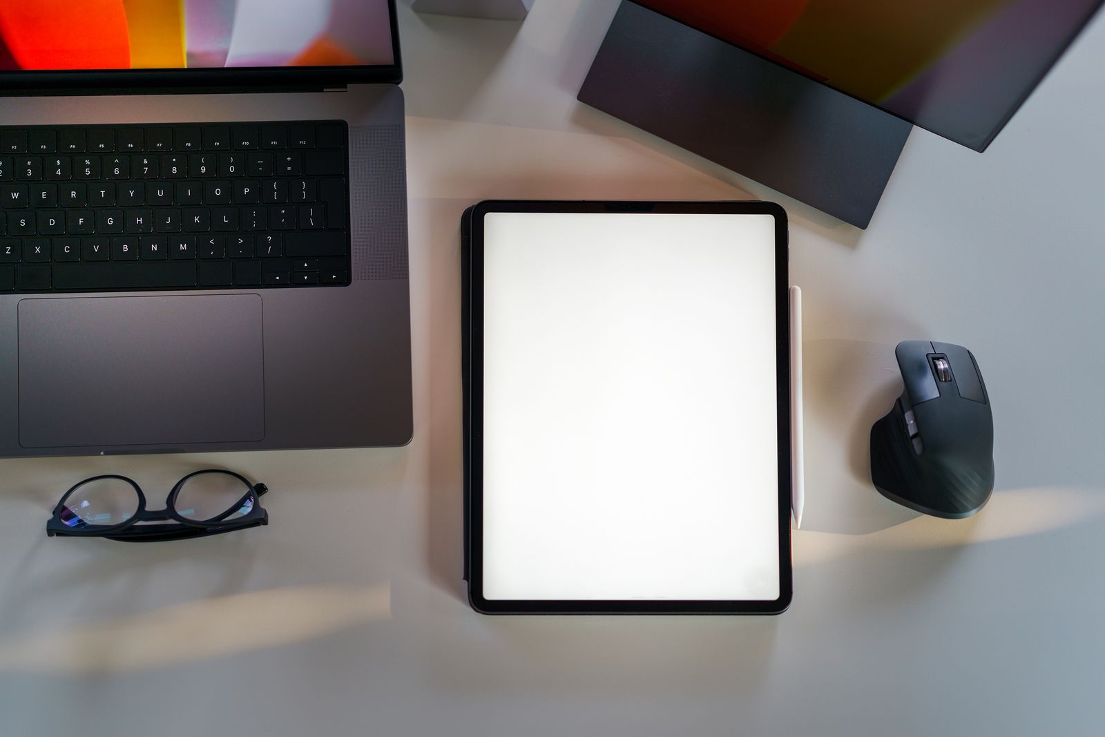 Laptop and tablet showing a website design mockup on an office desk