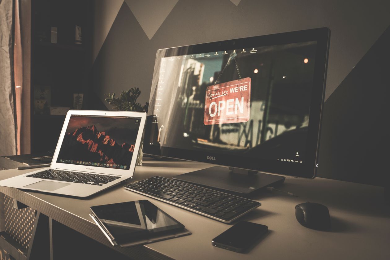 Workspace with a computer for managing WooCommerce hosting features